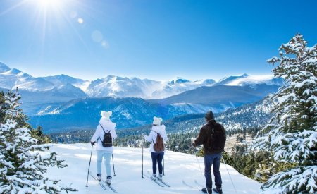 Active family skiing on winter vacation in Colorado.