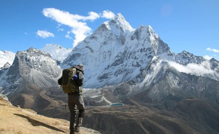 man with backpack hiking in mountains