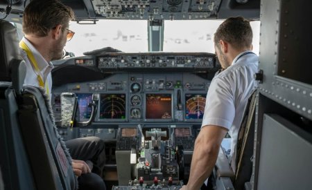 two pilots sitting inside plane
