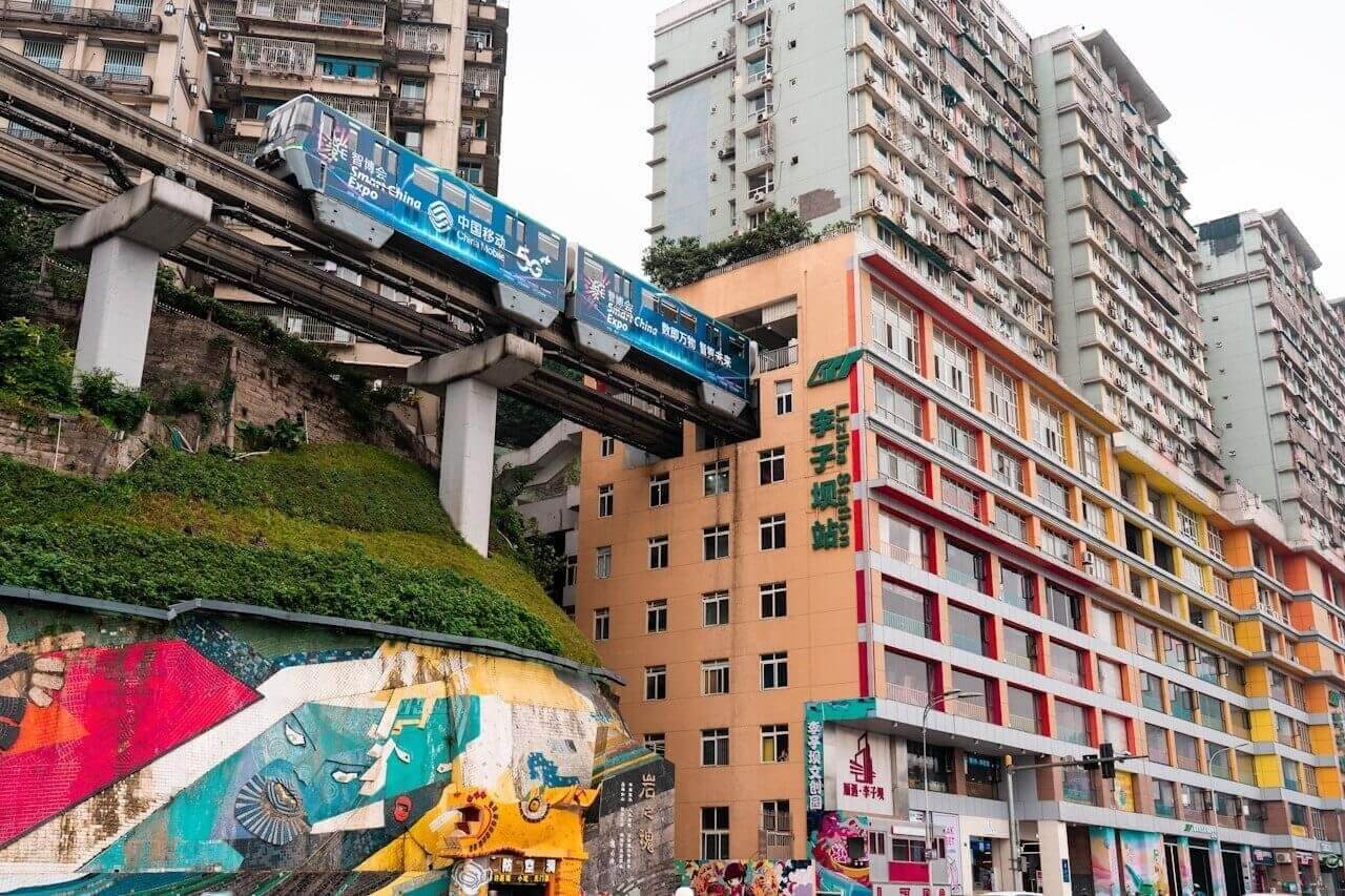 a group of people walking down a street next to tall buildings